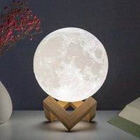 LED night light D5 Starry Moon Lamp casting a soft glow, featuring a detailed moon design on a wooden stand.