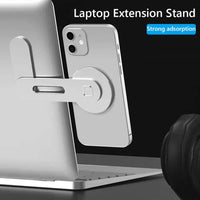 Magnetic phone holder attached to a laptop extension stand for convenient visibility and charging.