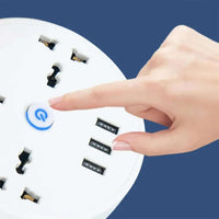 Power strip with USB ports showing a hand pressing the power button and multiple USB charging outlets.