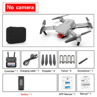 4K camera drone E88 Pro kit with controller, battery, propellers, and accessories laid out on a table.