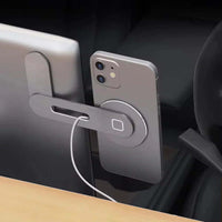 Magnetic phone holder with 15W fast charging attached to a laptop, showcasing convenience and versatility.