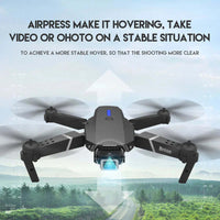 4K camera drone E88 Pro flying over a landscape with stable hover features for clear video recording.